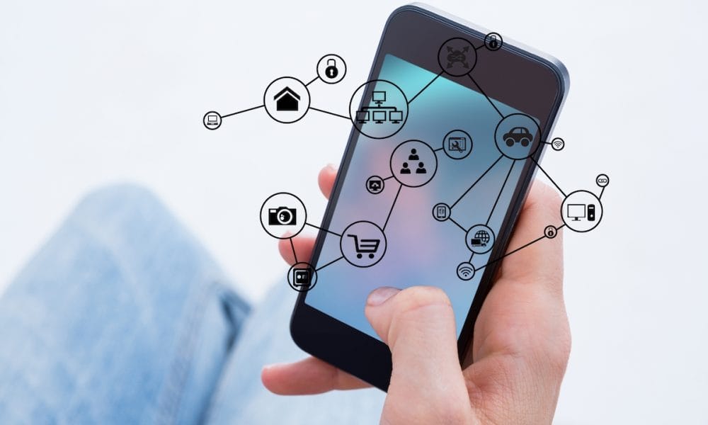 digital composite of hand holding smartphone with vignettes Medical centre becomes world’s first to adopt new tech