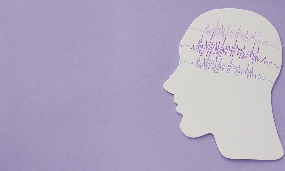 encephalography brain paper cutout with purple ribbon, Epilepsy awareness, seizure disorder, mental health concept Epilepsy patient samples pave way for potential new treatments