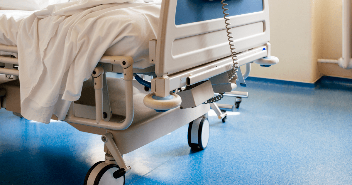 COVID: A hospital bed on a blue floor