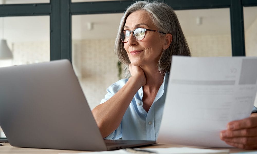 Smiling,Mature,Middle,Aged,Business,Woman,Using,Laptop,Working,On Mentally stimulating jobs ‘lower risk of dementia’