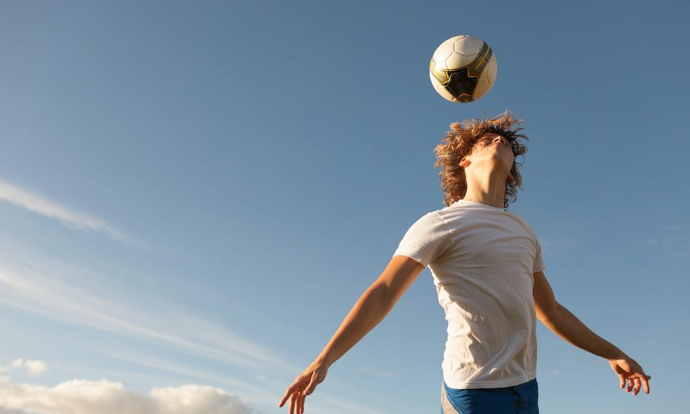 Soccer player hitting the ball with his head. ‘Make safety guidance enforceable rules’