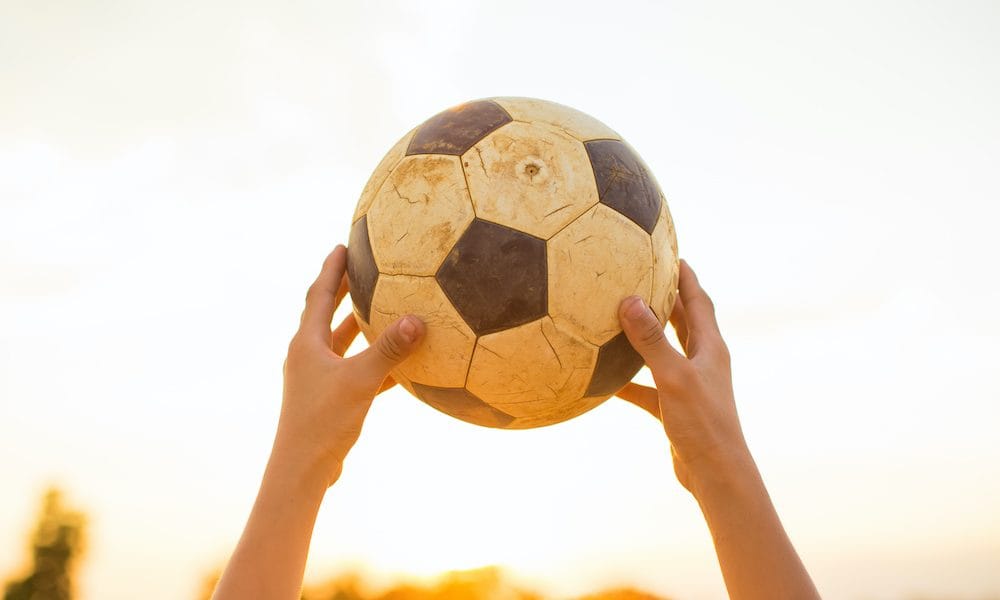 kids are playing soccer football for exercise in the evening. Saliva test to diagnose concussion set to trial in football