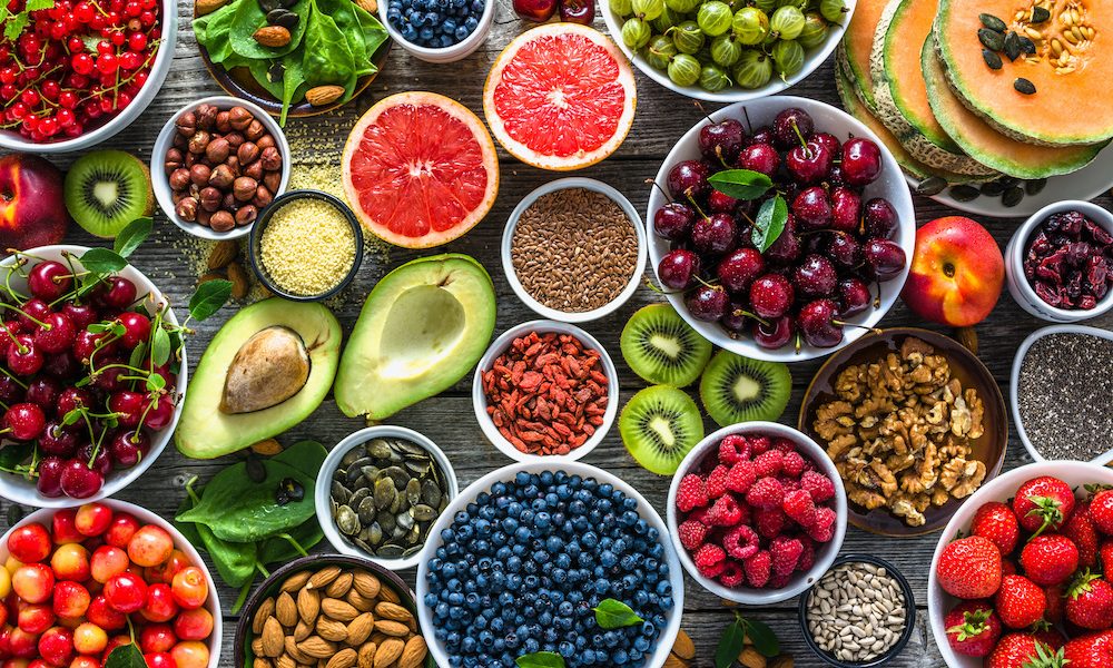 Selection of healthy food. Superfoods, various fruits and assorted berries, nuts and seeds. Nutrition and maximising rehab outcomes in older adults