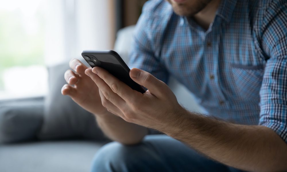 Hands of man using online virtual app on mobile phone Online tool ‘effective at assessing dementia risk’