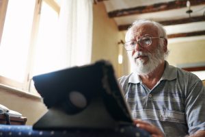 An elderly man checking his mental health with the AI therapist Earkick