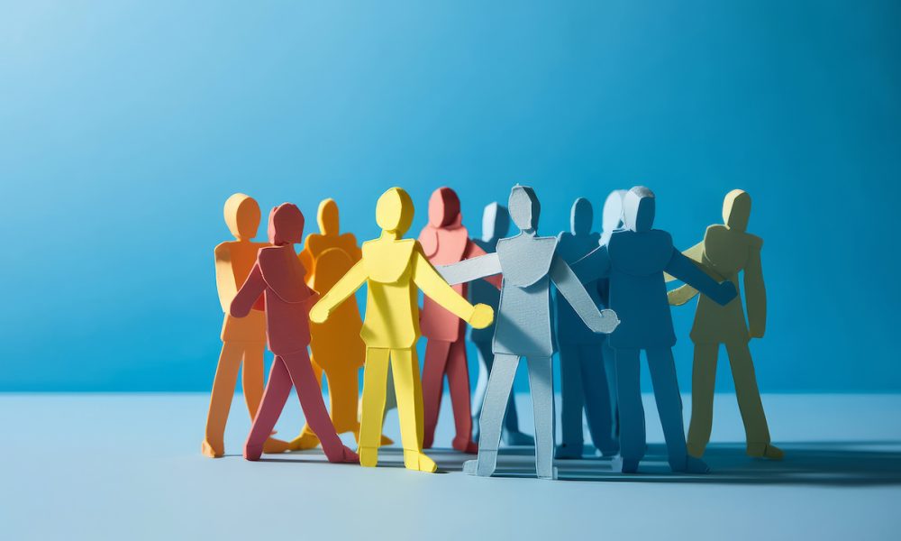 A group of paper people coming together. Community and friendship concept Supporting families after acquired brain injury – special report