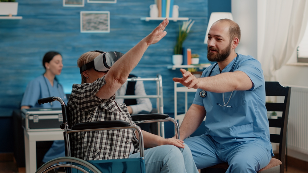 Retired woman using vr glasses and nurse assisting VR training task helps stroke recovery, study finds
