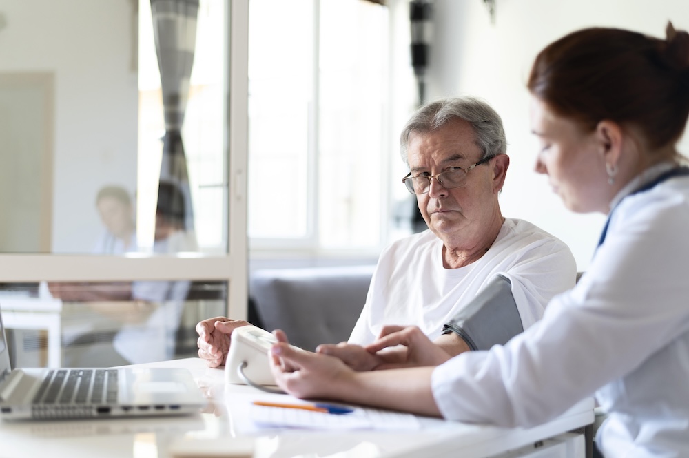 medium-shot-doctor-checking-old-patient Parkinson’s vaccine shows promise in clinical trial