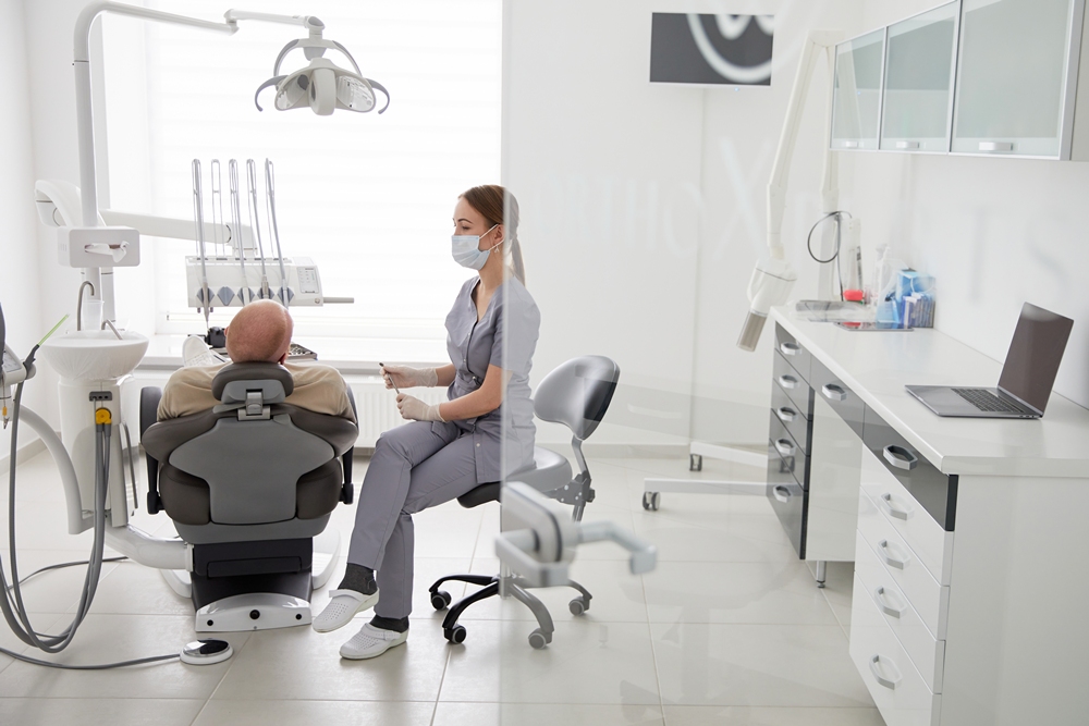 portrait-young-female-dentist-standing-by-mid-adult-man-clinic Dentists and GPs offered training to spot early signs of MND