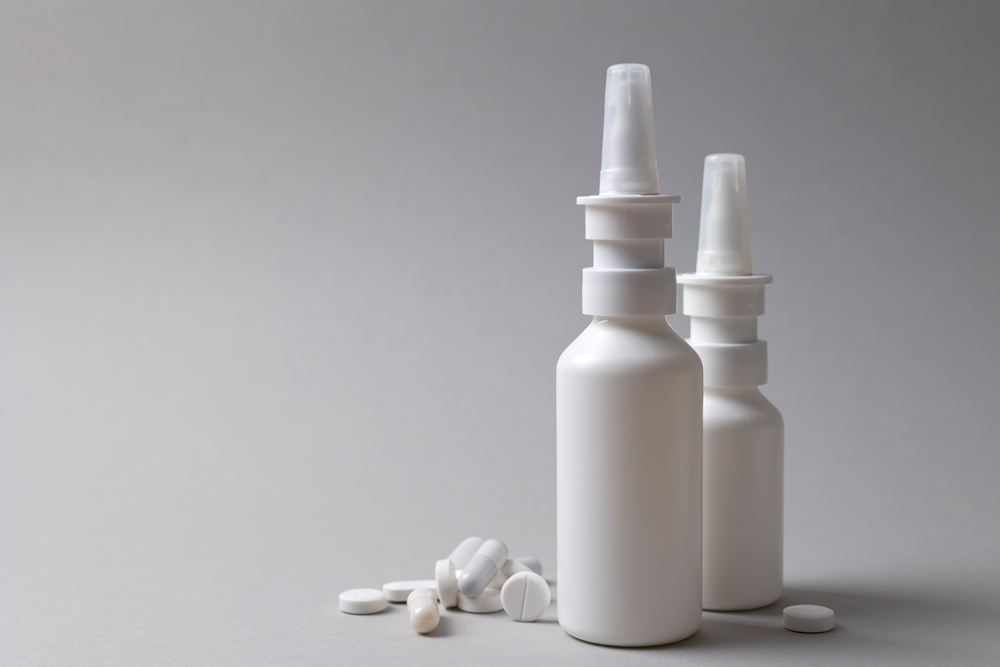 two-white-nasal-spray-bottles-pills-gray-background Nasal spray antibody trialled in early-stage ALS patients
