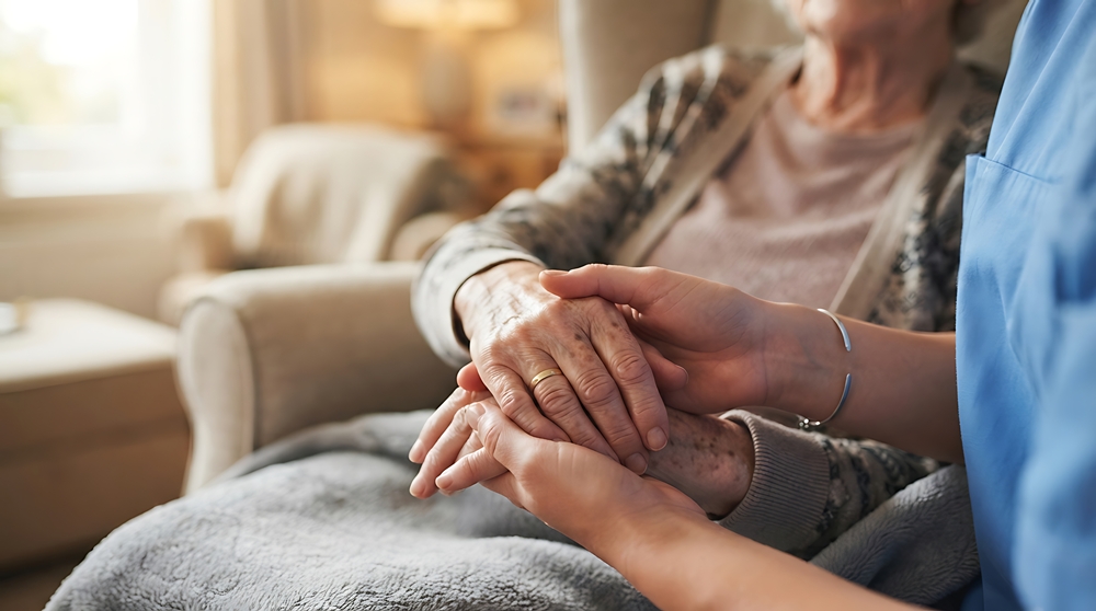 caregiver-holding-elderly-person-s-hands-care-home Care homes treated as ‘afterthought’ during pandemic, inquiry finds