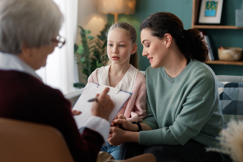 mother-daughter-family-therapy-session-with-professional-counselor-cozy-living-room Parental stress linked to lower self-esteem in children with MS, study finds