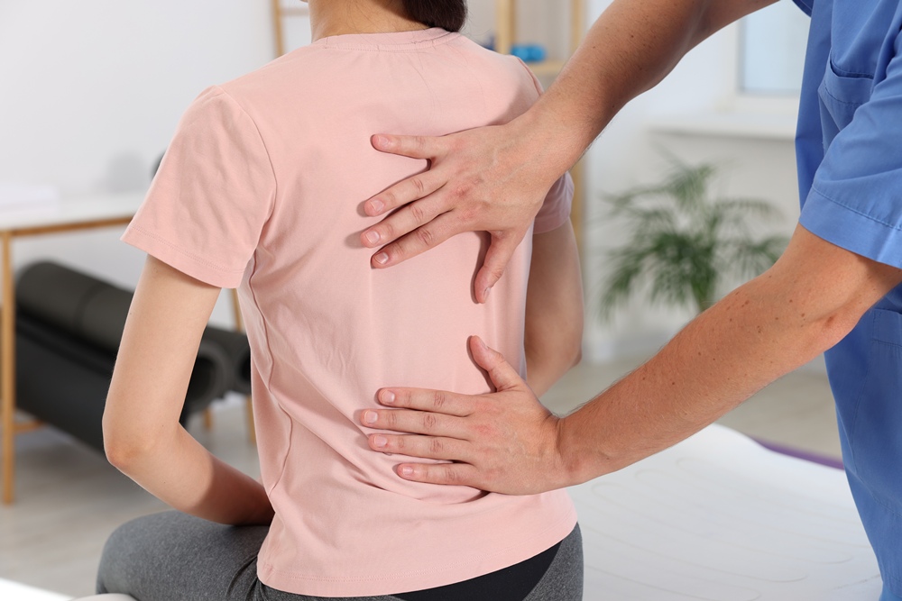 Physiotherapist working with patient in rehabilitation center, closeup Spinal cord injury trial offers hope of restoring bladder control with implant